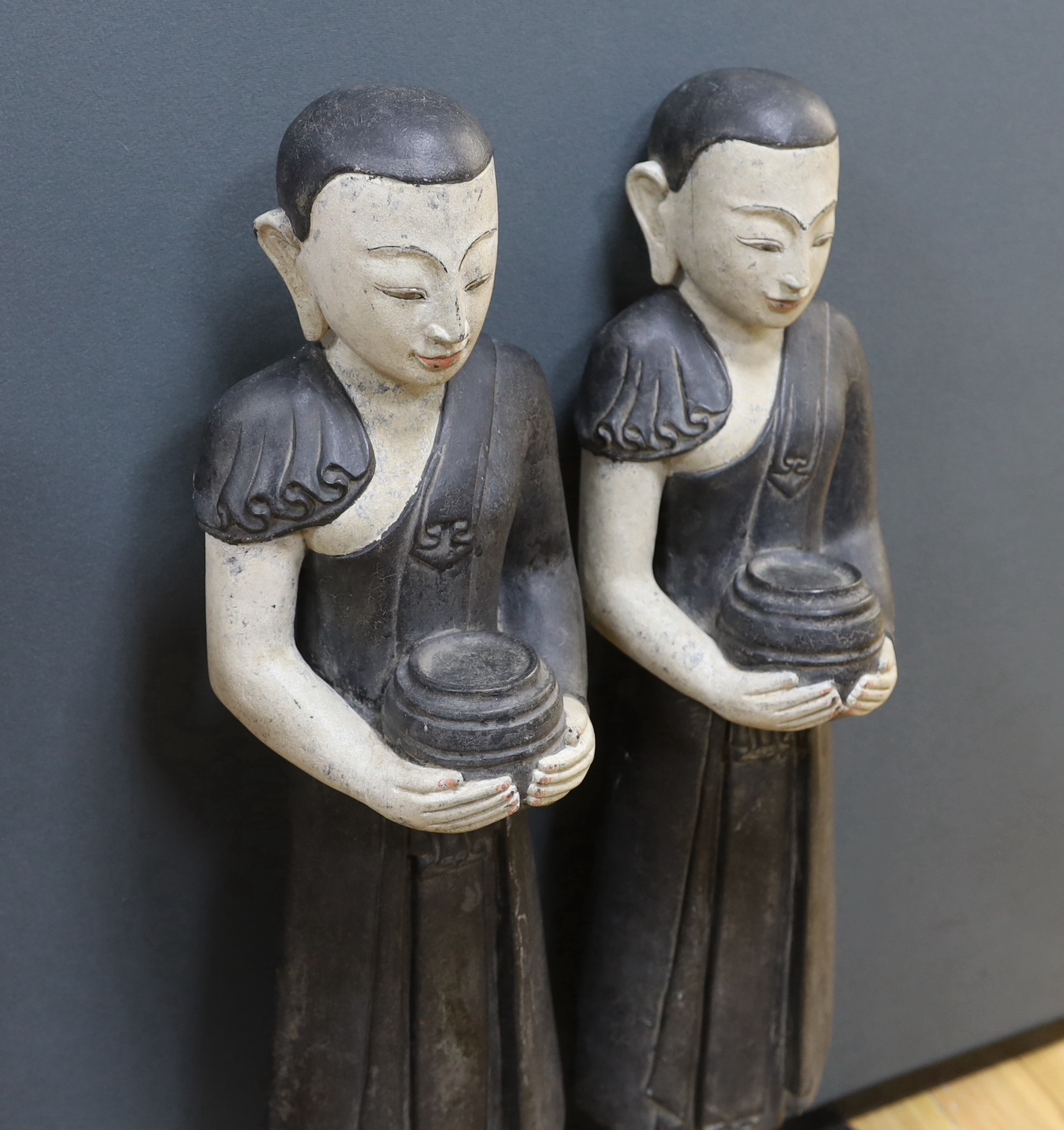 A pair of floor standing Thai figures, 80cm high